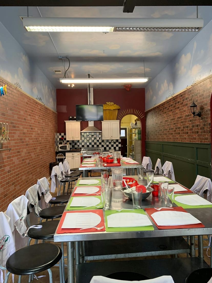 Culinary school event space with long dining table for cooking classes in Cucina Bambini.