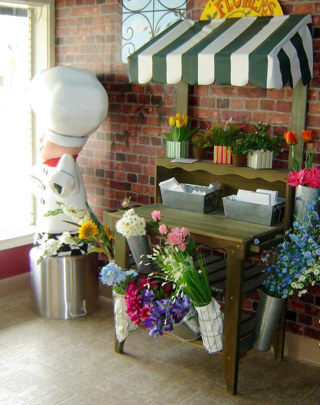 Culinary school floral display on rustic table, perfect for receptions and networking events.