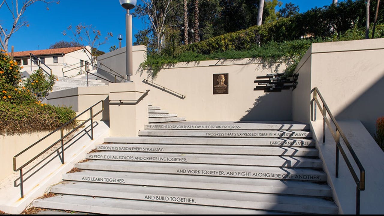Black Scholars Community staircase with inspirational quotes for team-building events.
