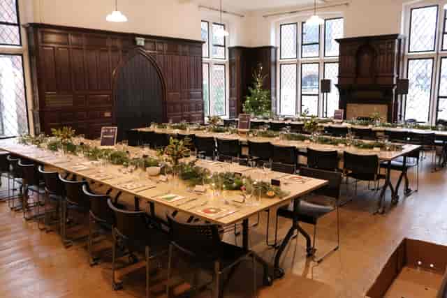 U-shape meeting room in Toynbee Hall with festive greenery for banquet or corporate event.