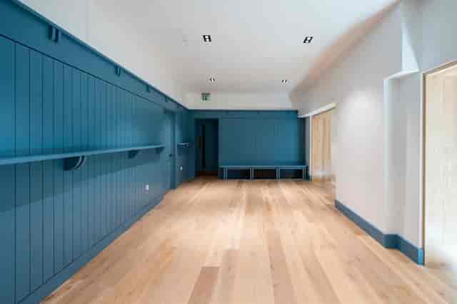 Modern Meeting Room 1 at Toynbee Hall with blue paneling for versatile events.