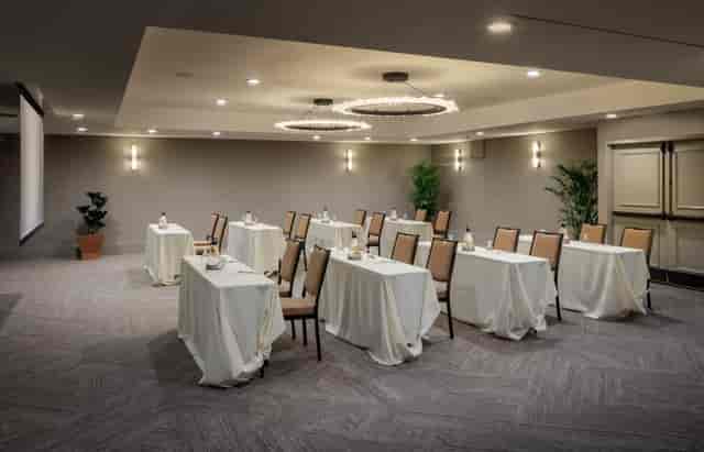 Private banquet meeting space at Toll House Hotel, featuring elegant tables and projector.