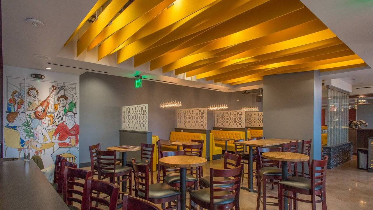 Vibrant dining room with yellow ceiling, perfect for networking events and social functions.