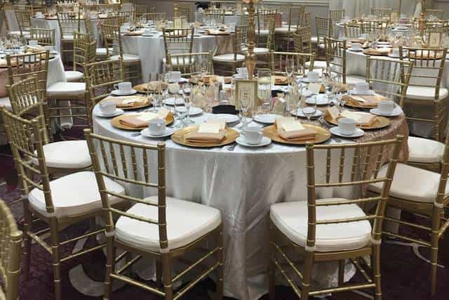 Elegant banquet room with round tables, ideal for weddings and corporate events.