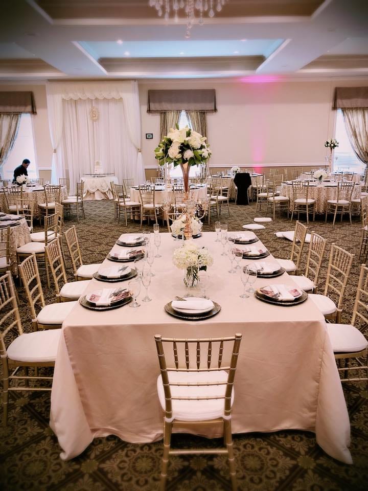 Elegant banquet hall with gold chiavari chairs, perfect for formal events and celebrations.