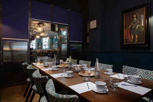 Intimate meeting room with wooden table, ideal for professional gatherings and events.