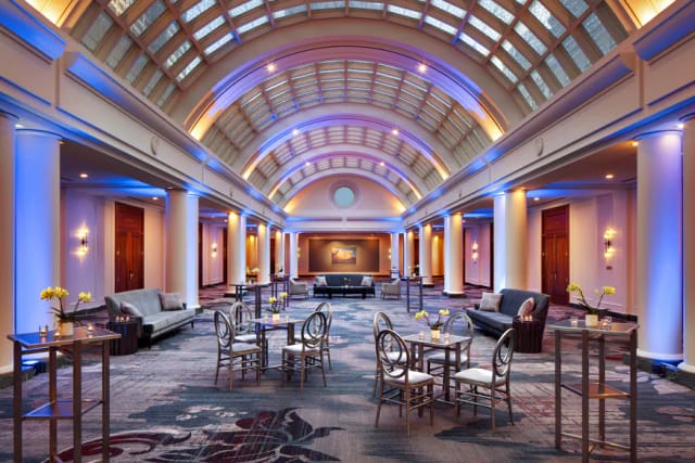 Elegant event space with high ceilings, perfect for corporate gatherings and receptions.