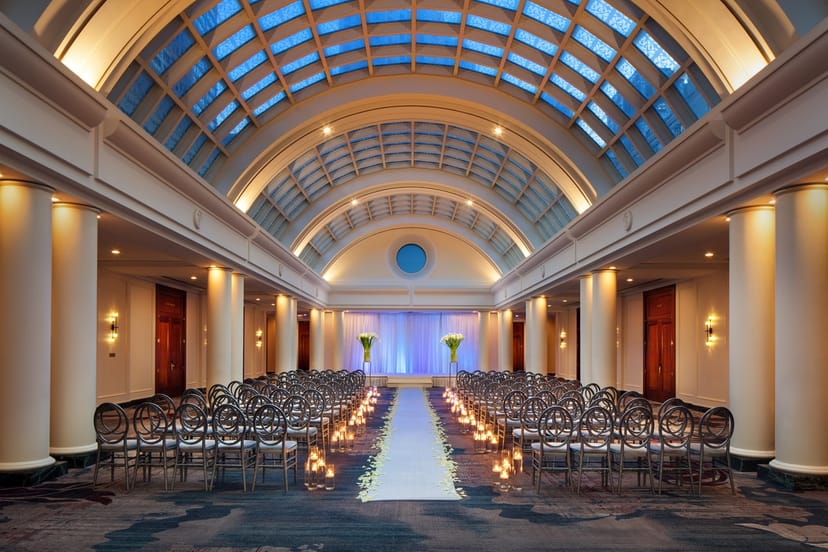 Elegant event space with arching ceiling, ideal for weddings and formal gatherings.