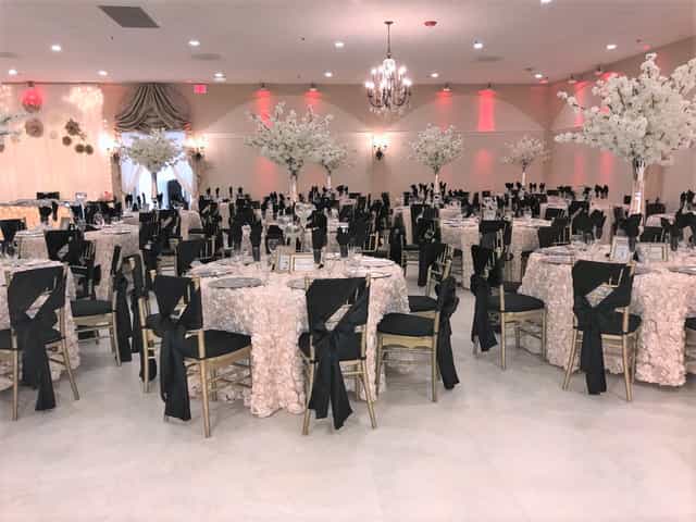 Elegant event space in Maji Palace with floral centerpieces, ideal for weddings and gatherings.