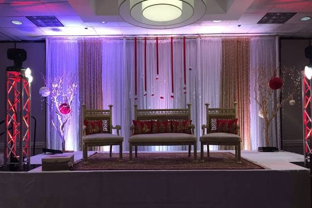 Champagne Ballroom stage with elegant drapery, perfect for weddings and formal events.