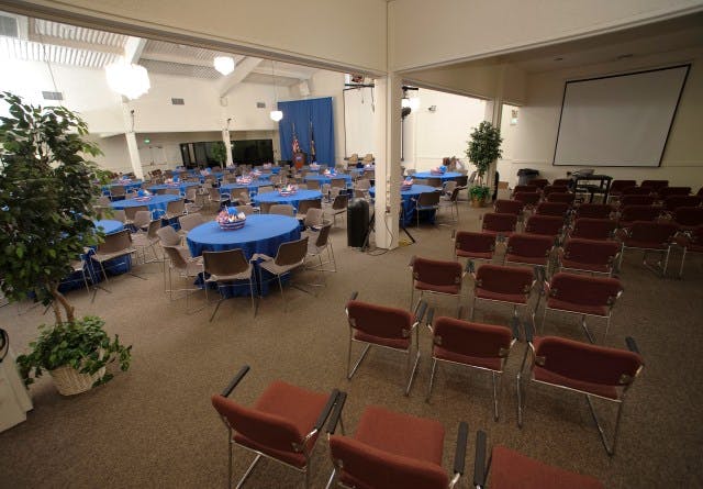 Ballroom at NASA Ames Conference Center with blue tables, ideal for conferences and banquets.