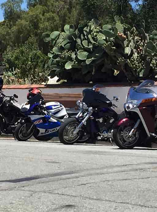 San Jose Dons Motorcycle Club rally with diverse motorcycles along a scenic route.