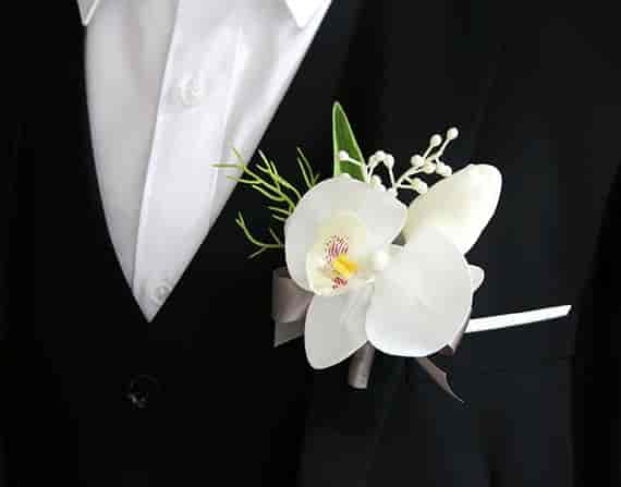 Elegant white orchid boutonnière for weddings and formal events at Lily Duong Garden Shop.