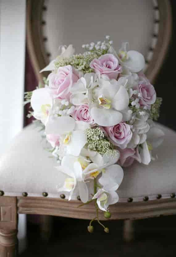 Bridal bouquet with pink roses and white orchids for elegant weddings and events.