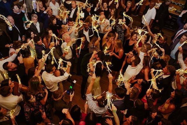 Vibrant gala in Suite 109, Los Gatos DJ Company, with guests raising sparklers.