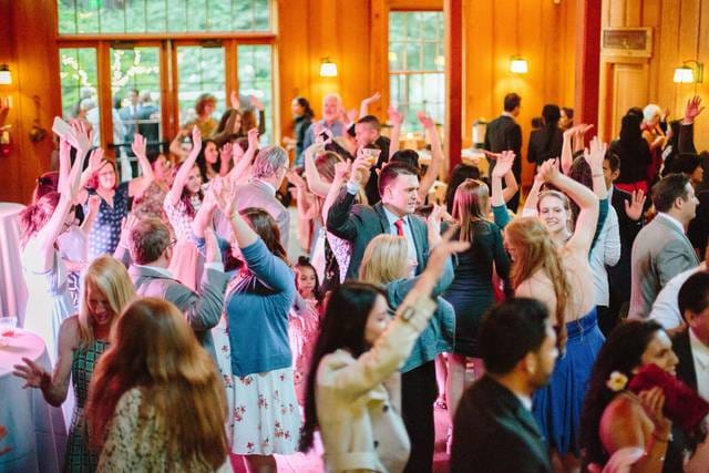 Vibrant event scene in Suite 109 #154, showcasing dancing and networking opportunities.