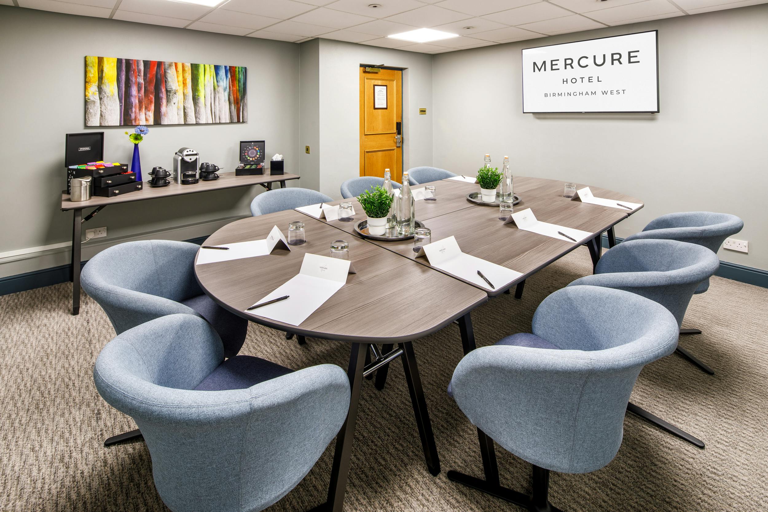 Modern meeting room with oval table at Mercure Birmingham West Hotel for events.