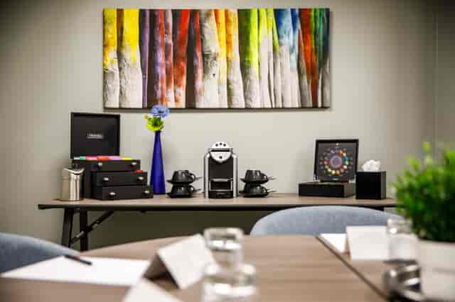 Modern meeting space at Mercure Birmingham West Hotel with coffee station and vibrant decor.