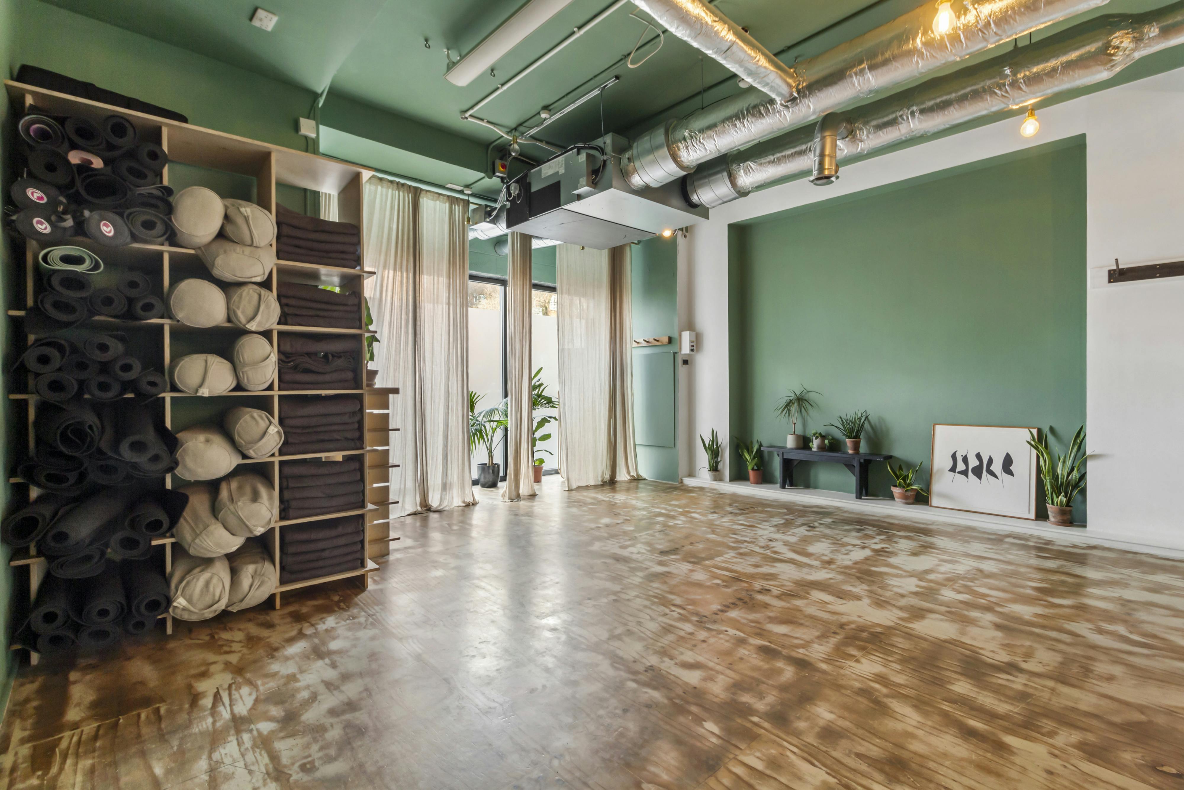 Yoga studio with natural light, perfect for wellness events and retreats.