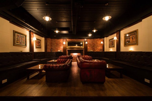 Sophisticated lounge at The Hatch Club with warm lighting, ideal for networking events. - Banner