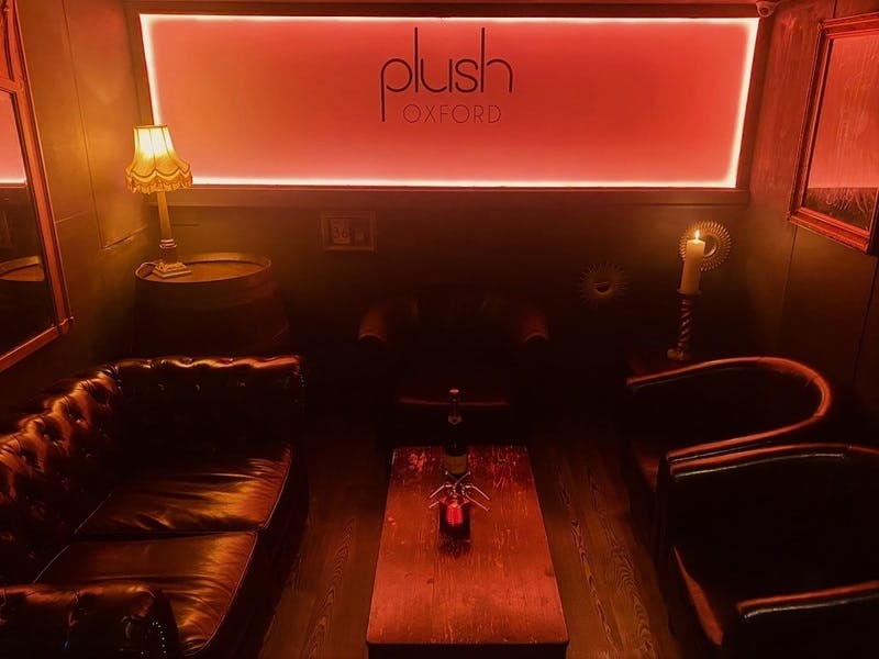 VIP lounge in Plush Oxford with cozy seating for networking events and private functions.