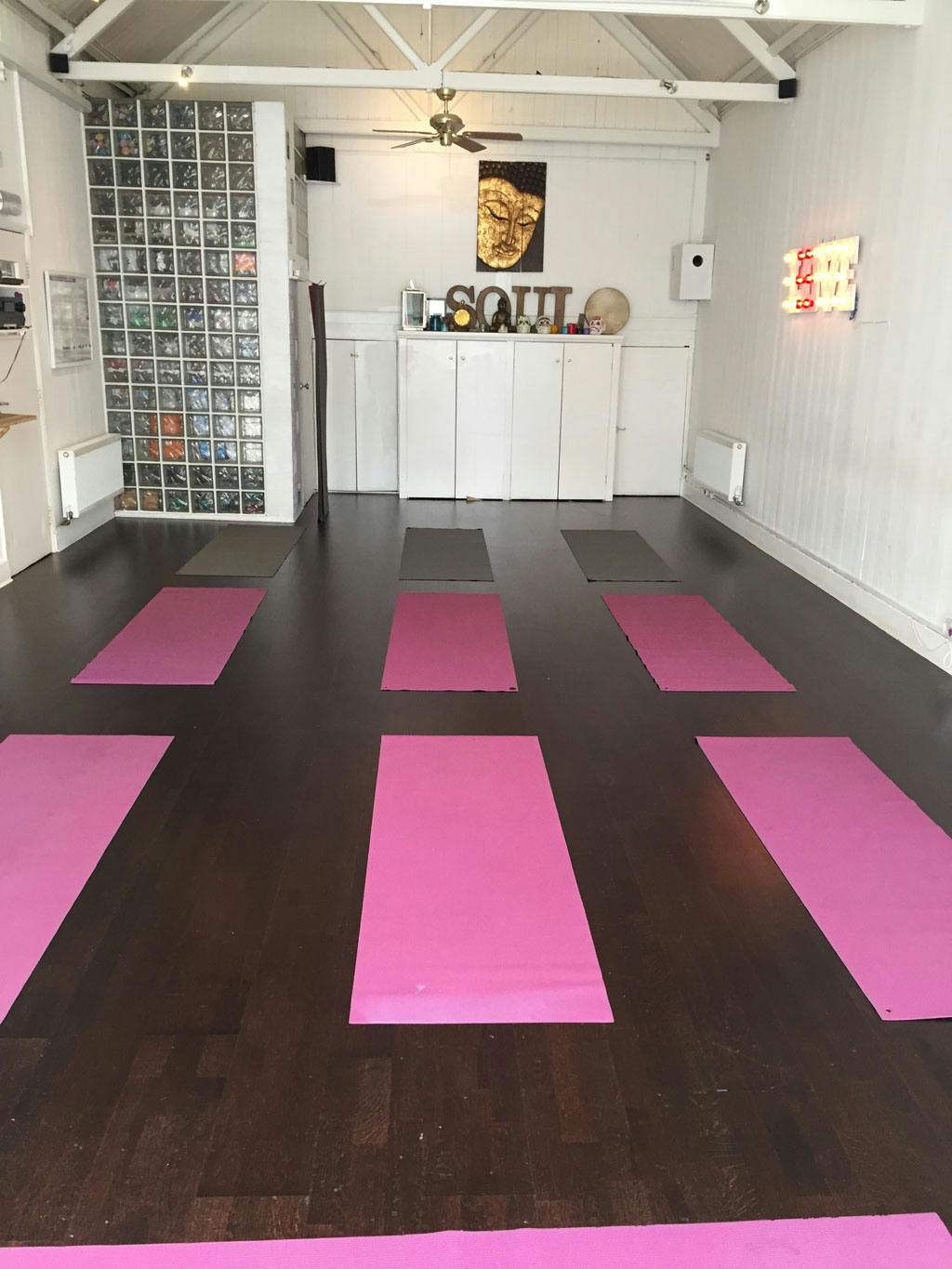 Serene yoga studio with pink mats, ideal for wellness retreats and mindfulness sessions.