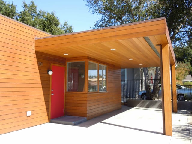 Modern entrance of Neutra House Conference Center with red door for events and meetings.