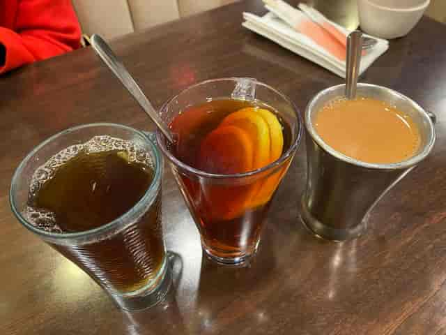 Beverages at Venus Cafe: iced drink, warm tea, chai for networking event.