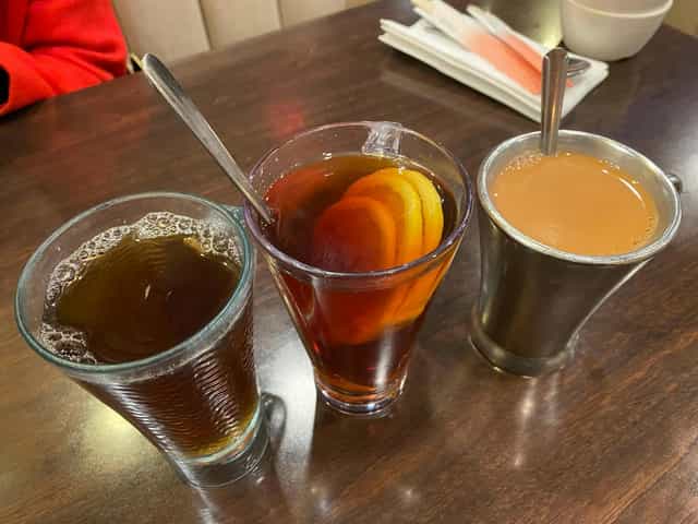 Beverages at Venus Cafe: iced drink, warm tea, chai for networking event.