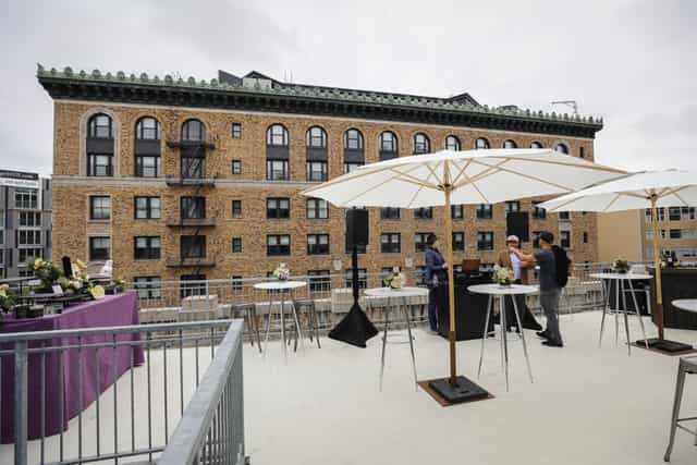 Stylish rooftop event space with high-top tables, ideal for cocktail receptions.