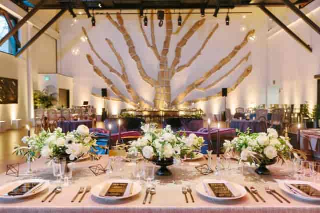 Elegant event space at The Pearl with floral centerpieces, ideal for weddings and gatherings.