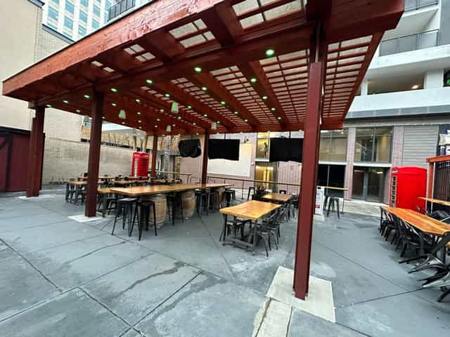Spacious patio with pergola, ideal for casual gatherings and networking events.