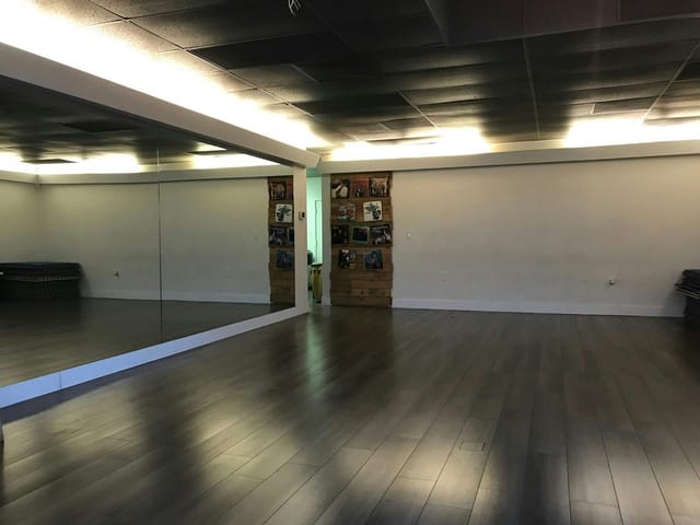 Versatile event space with polished wooden flooring, ideal for workshops and fitness classes.