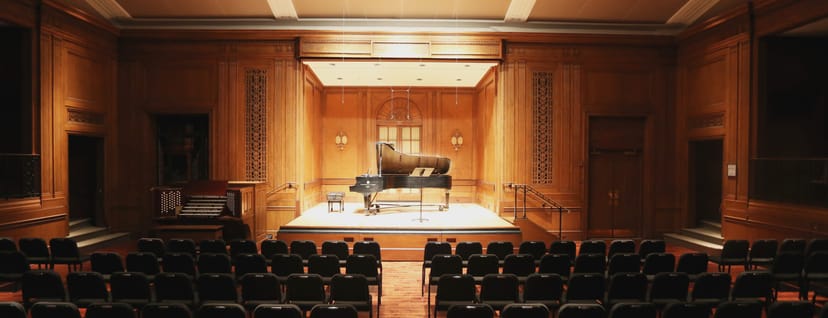 Concert Hall with wooden paneling, ideal for intimate concerts and recitals.