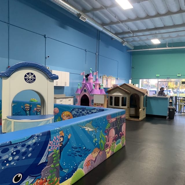 Vibrant party room with colorful play structures for children's birthday events.
