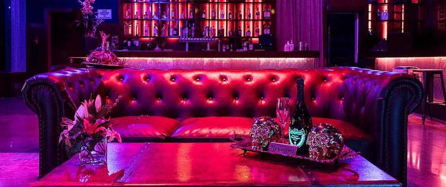 Luxurious lounge with plush red seating, ideal for upscale events and gatherings.