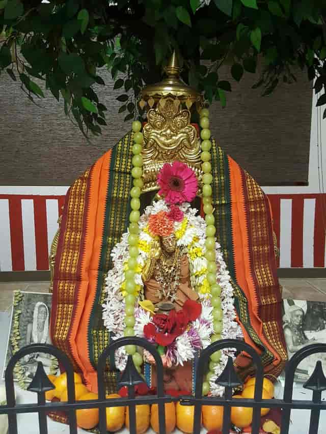 Deity statue at Sri Kamakshi Community Center, vibrant flowers for cultural events.
