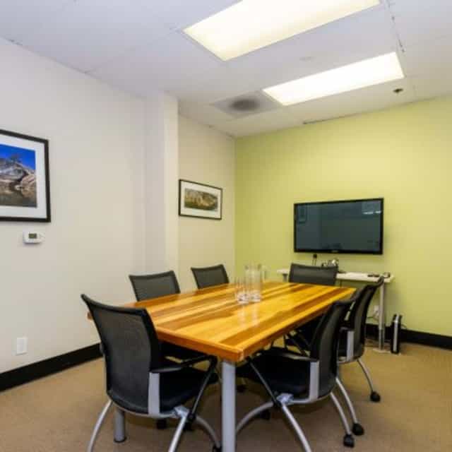 Modern meeting room with wooden table for collaboration in Los Gatos Executive Center.