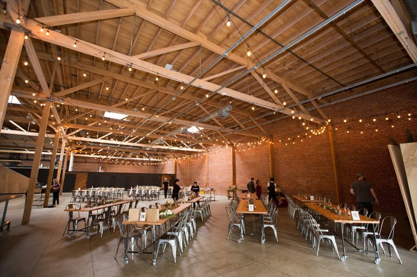 Rustic event venue with high ceilings, ideal for banquets and receptions.