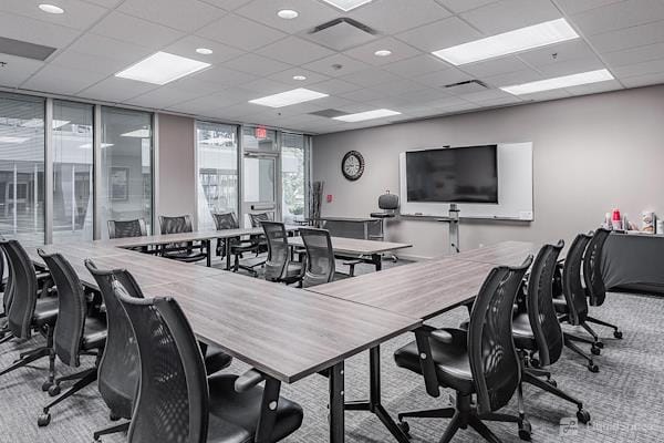 Private meeting room with U-shaped table, ideal for collaborative discussions and presentations.