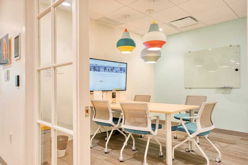 Modern meeting room with sleek table, ergonomic chairs for corporate events.