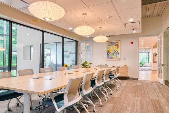 Modern conference room with spacious table, ideal for meetings and presentations.