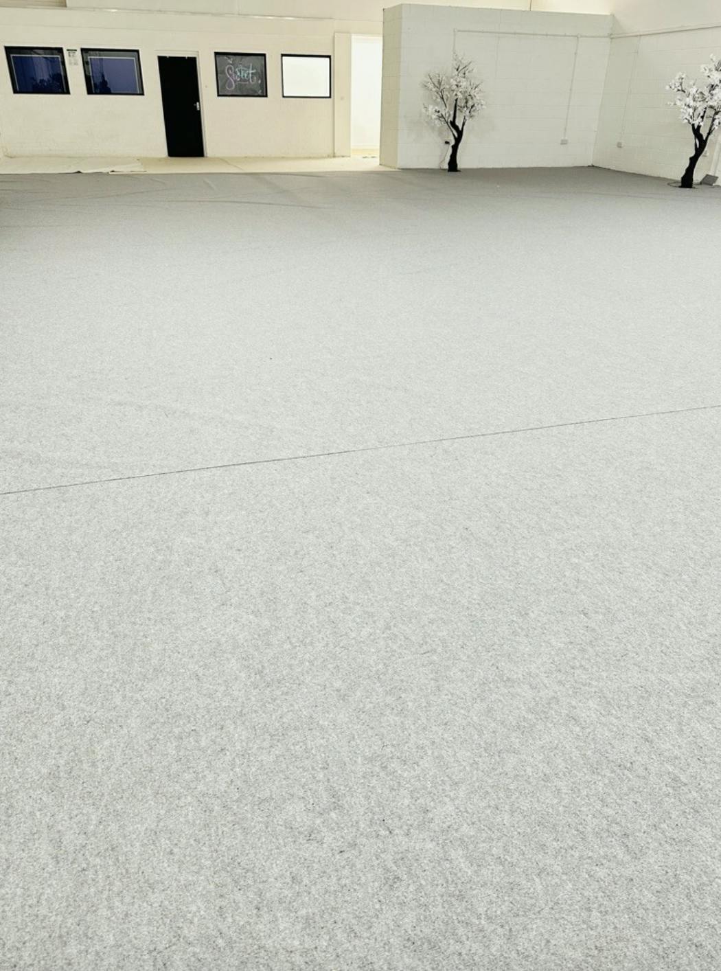 Neutral event space with smooth floor, perfect for versatile setups and exhibitions.