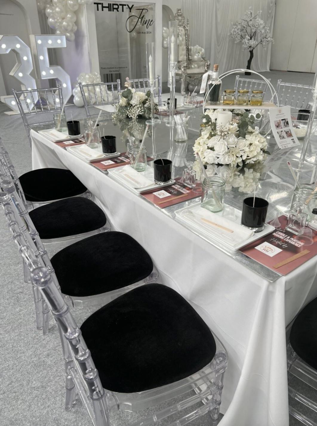 Elegant event table with glassware and floral centerpiece for upscale gatherings.