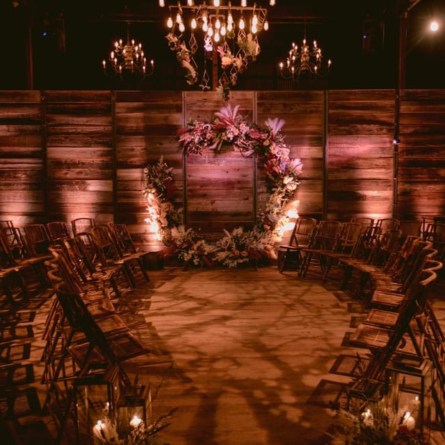 Private event space with floral arch and rustic decor for intimate gatherings.