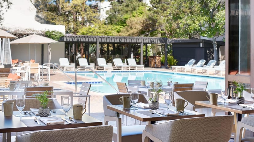 Poolside Bar at The Westin Palo Alto with inviting outdoor dining near a sparkling pool.