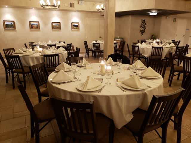 Elegant dining area with round tables in Wine Cellar Los Gatos for corporate events.