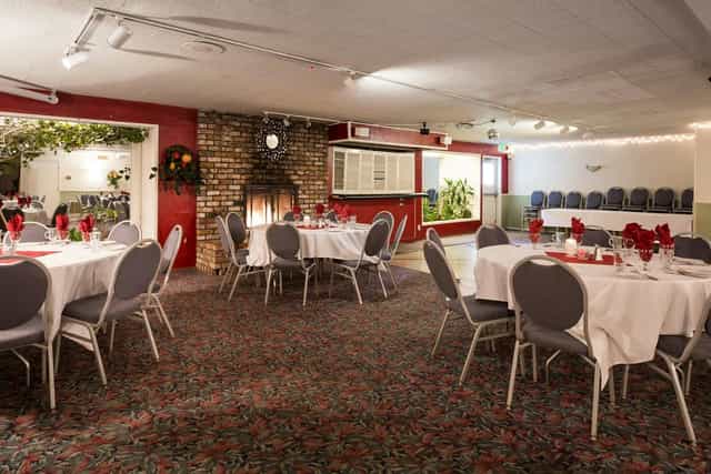 Elegant banquet space with round tables, ideal for events and gatherings at The Blue Pheasant.