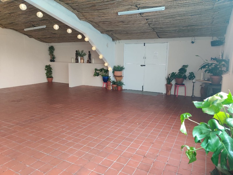 Versatile event space with terracotta flooring, ideal for intimate gatherings and workshops.