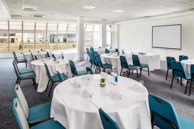 Pilgrim Suite meeting space with elegant round tables for professional events.